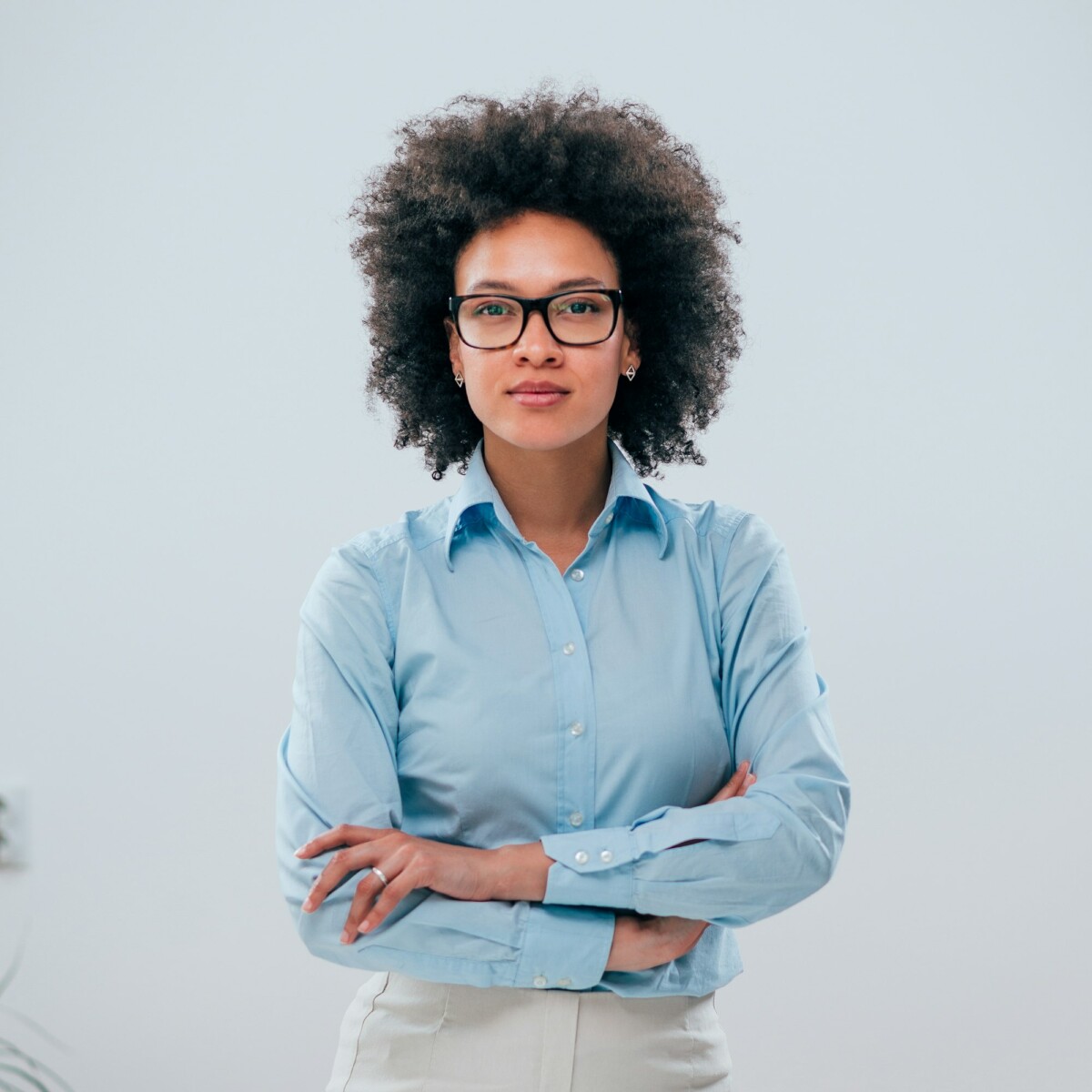 Portrait of a confident businesswoman with curly hair on isolated background .jpg